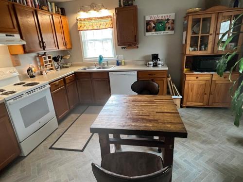 a kitchen with a wooden table and a table and chairs at Sir Happy's Place in Elkins