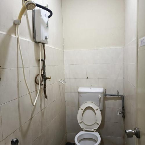 a bathroom with a toilet in a stall at Meple Hotel Skudai in Skudai