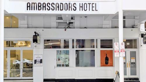 a building with a sign on top of it at Ambassadors Hotel in Adelaide