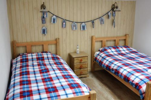 Säng eller sängar i ett rum på The Barn at Cae Bach
