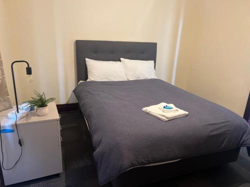 a bedroom with a bed with a towel on it at Commercial Hotel Dowerin in Dowerin