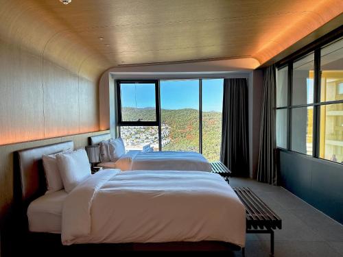 Ένα ή περισσότερα κρεβάτια σε δωμάτιο στο Ananti at Busan Village