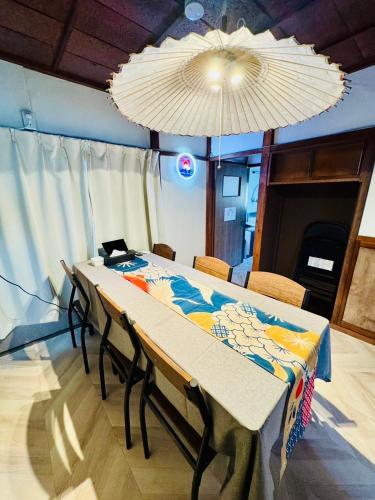 a table with chairs and a chandelier in a room at BUSHIDO Kinugawa -Nikko-Tochigi in Nikko