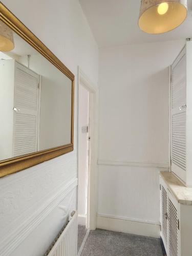 a bathroom with a mirror on the wall at Suncrest Hotel in Blackpool