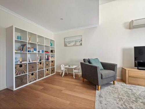 a living room with a chair and a table at 63@CapeView, Geographe bay in Busselton