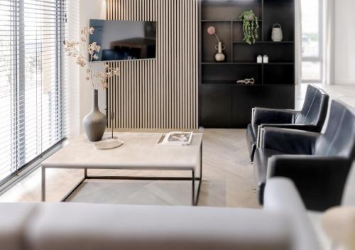 a living room with a table and chairs at 4-Bed Apartment Kitchen Free Parking in Ledeacker
