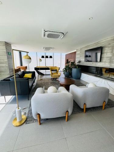a living room with two couches and a table at Apartment in Alameda in Tijuana