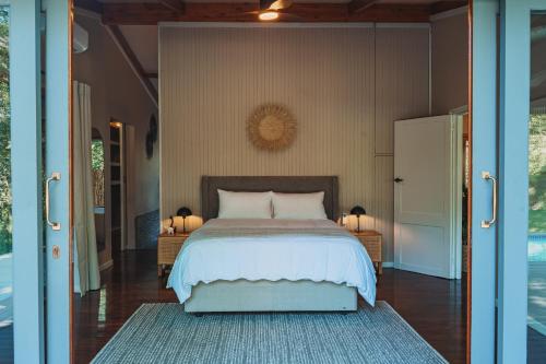 a bedroom with a bed and two lamps on tables at The Grand Luxury Safari Villa, Huge Private Pool, Hottub, Outdoor Shower, Giraffe Tower in Hluhluwe