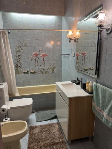 a bathroom with a sink and a toilet and a tub at Beach front at Carvalhido in Póvoa de Varzim