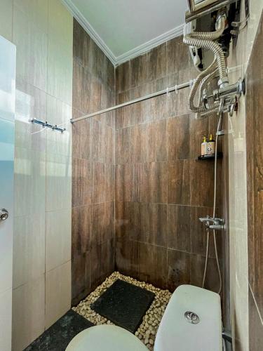 a bathroom with a shower with a toilet in it at Omah Ulfah Homestay in Banyuwangi