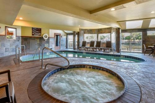 a hot tub in the middle of a hotel room at Kathryn Riverfront Inn, an Ascend Collection Hotel in Seaside