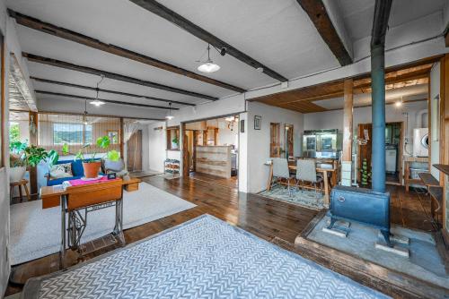 a living room with a table and a fireplace at Peace Garden Furano in Nakafurano