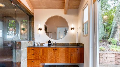 a bathroom with a sink and a mirror at Sonoma Skyhouse by AvantStay Pool Sauna Hot Tub Stunning Valley Views in Sonoma