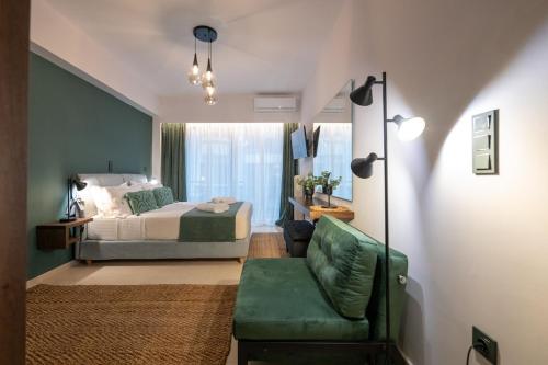 a bedroom with a bed and a green couch at Urban Nest in Kalamata
