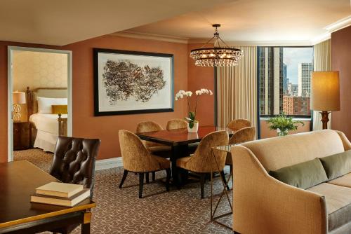 a living room with a dining room table and a bedroom at The Rittenhouse Hotel in Philadelphia