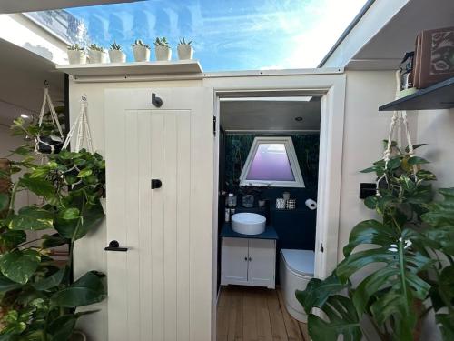 a bathroom with a toilet and a sink at The Floating Terrarium in London