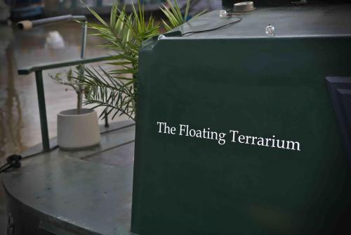 a green sign that reads the floating tentium at The Floating Terrarium in London