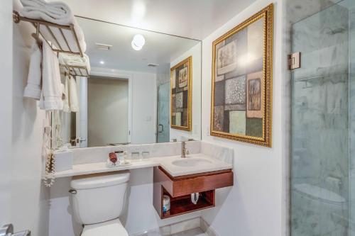 a bathroom with a toilet and a sink and a shower at The Historic Blue Angel Hotel Lexington Ave, an Ascend Collection in New York