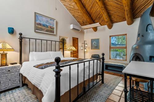 a bedroom with a bed and a desk in a room at Casas de Suenos Old Town Historic Inn, an Ascend Collection Hotel in Albuquerque