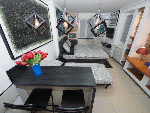 a living room with couches and a table and flowers at Galerija MARSHAL in Belgrade