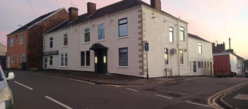 a white building on the side of a street at THE NEW Accommodation FREE complementary breakfast in Tibshelf