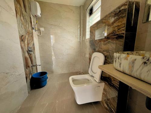 a bathroom with a toilet and a sink at Staymist - Pool and Pause Villa in Nagaon