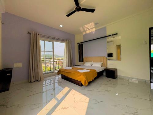 a bedroom with a bed and a large window at Staymist - Pool and Pause Villa in Nagaon