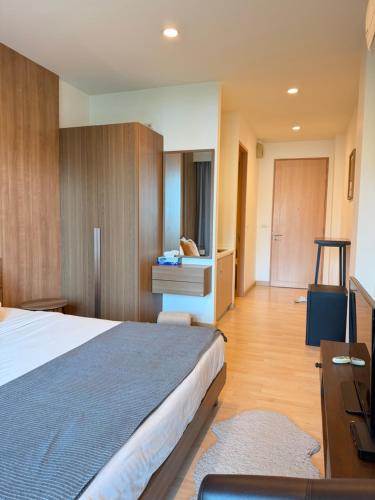 a hotel room with a large bed and a desk at The H2O Khao Yai in Ban Rai Khlong Sai