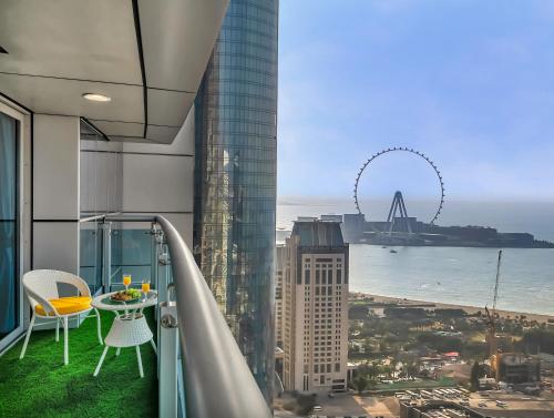 a balcony with a view of the city and the ocean at SKY HIGH 2 BHK # Ain Dubai & Sea View # Marina & JBR in Dubai