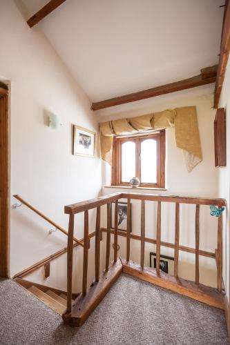 a room with a staircase and a window at Skipbridge Farm Cottages in Green Hammerton