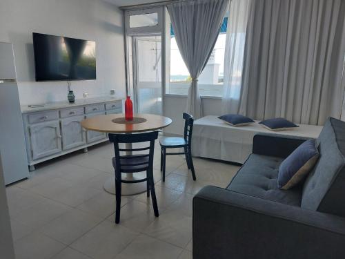 a living room with a couch and a table and a bed at Apartahotel Estudio 332 in Matalascañas