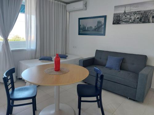 a living room with a table and a couch at Apartahotel Estudio 332 in Matalascañas