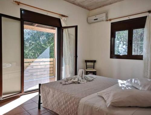 a bedroom with a bed and a large window at Villa del Alma in Planos