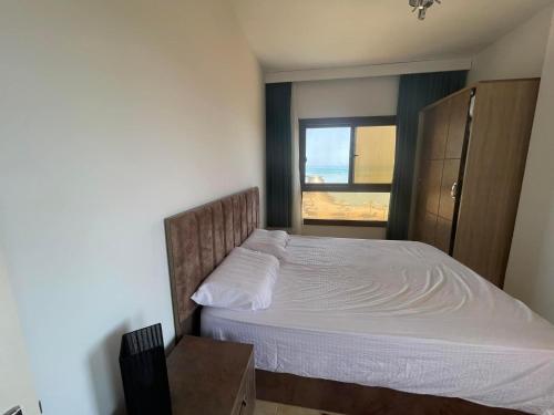 a bedroom with a large bed with a window at Turtles beach resort in Hurghada