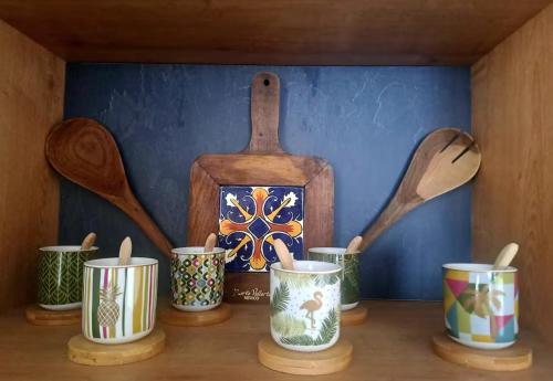 a shelf with pots and spoons and a wooden box at Lovely flat in a great location in Košice