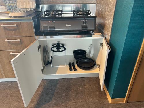 a kitchen with a stove in an open cabinet at BOTH ISUMI - Vacation STAY 06710v in Isumi