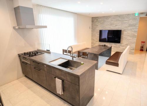a kitchen with a sink and a living room at BASK HOTA - Vacation STAY 73778v in Minamiboso