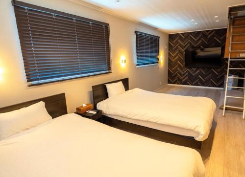 a bedroom with two beds and a window at BASK HOTA - Vacation STAY 73778v in Minamiboso