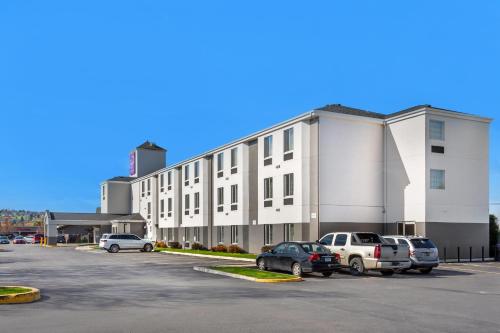 a large white building with cars parked in a parking lot at Sleep Inn Missoula Southgate in Missoula