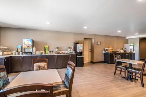 a restaurant with tables and chairs and a kitchen at Elevate Hotel at Sierra Blanca Ruidoso, an Ascend Collection Hotel in Ruidoso