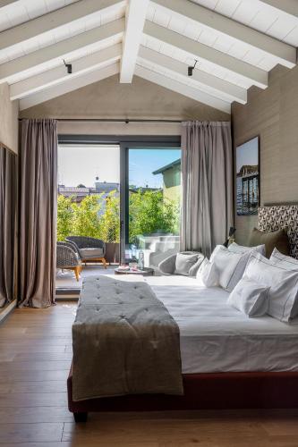 a bedroom with a large bed with a large window at Il Mansio Vegan Hotel and Restaurant in Desenzano del Garda
