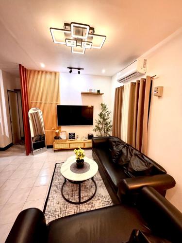 a living room with a couch and a table at RKs Cozy Balai in General Santos