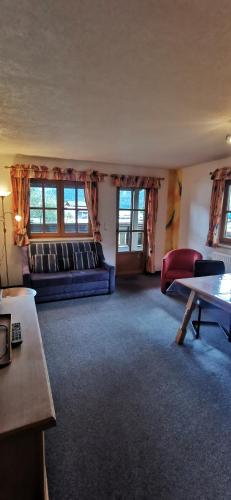 a living room with a couch and a table at Haus Bergmassiv in Lermoos