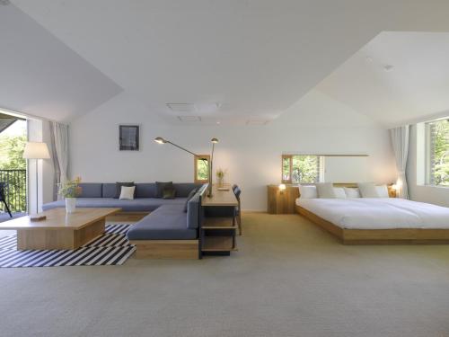 a large bedroom with two beds and a couch at Hakone Retreat Före in Hakone