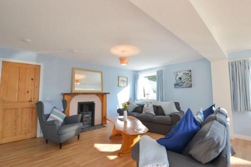a living room with a couch and a fireplace at Stunning Coastal Home - Garden, Views, Pet Friendly in Connel
