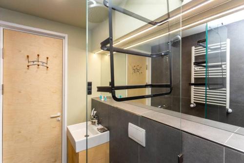 a bathroom with a sink and a mirror at 1BR apart 1 min from M Kokhta 3rd floor in Bakuriani