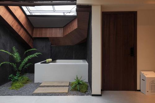 a bathroom with a bath tub in a room at Return Courtyard Hotel in Chengdu