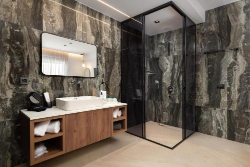 a bathroom with a sink and a mirror at Lanik Luxury Pool Villa in Afantou