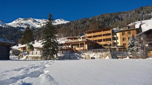 a ski lodge in the mountains with snow at Almi's Berghotel in Obernberg am Brenner