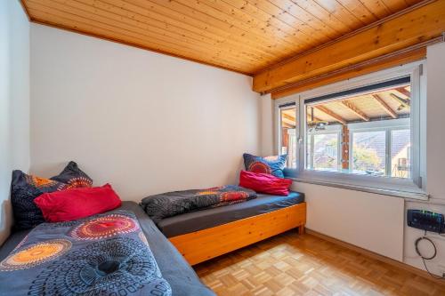 a small room with a bed and a window at Ferienwohnung Agnes in Rappersweier